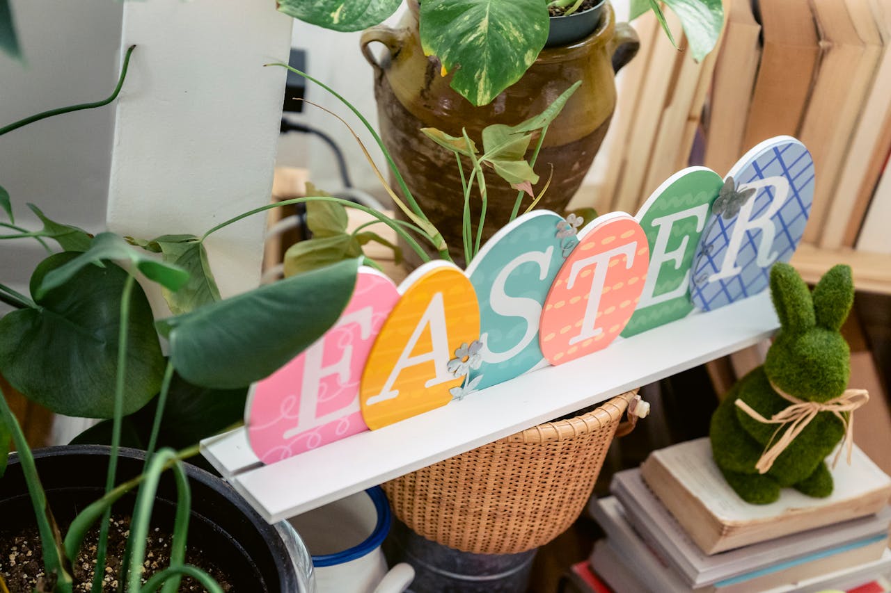 Festive Easter sign with plants and books creating a cozy indoor vibe.